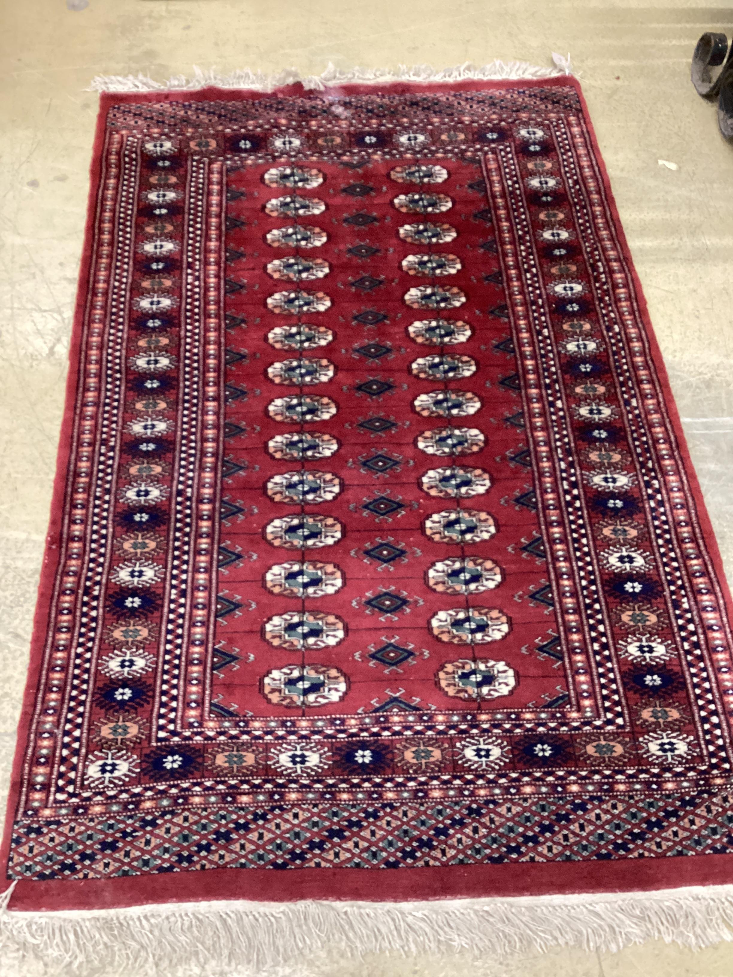 A Bokhara red ground rug, 150 x 96cm